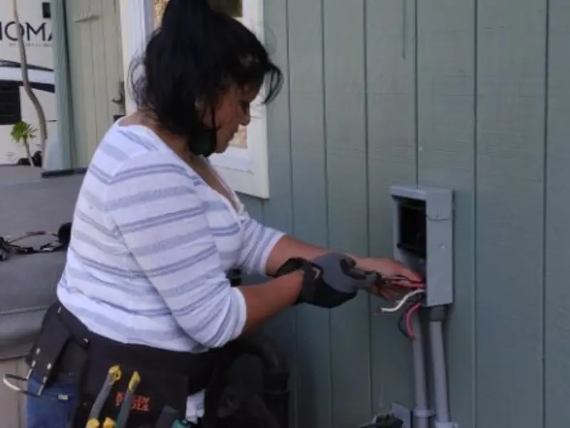 Licensed electrician wiring an exterior subpanel in Monticello